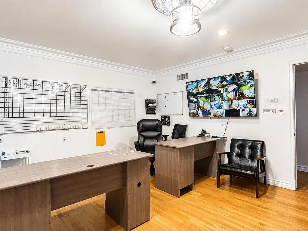 A shared office with desk and artwork