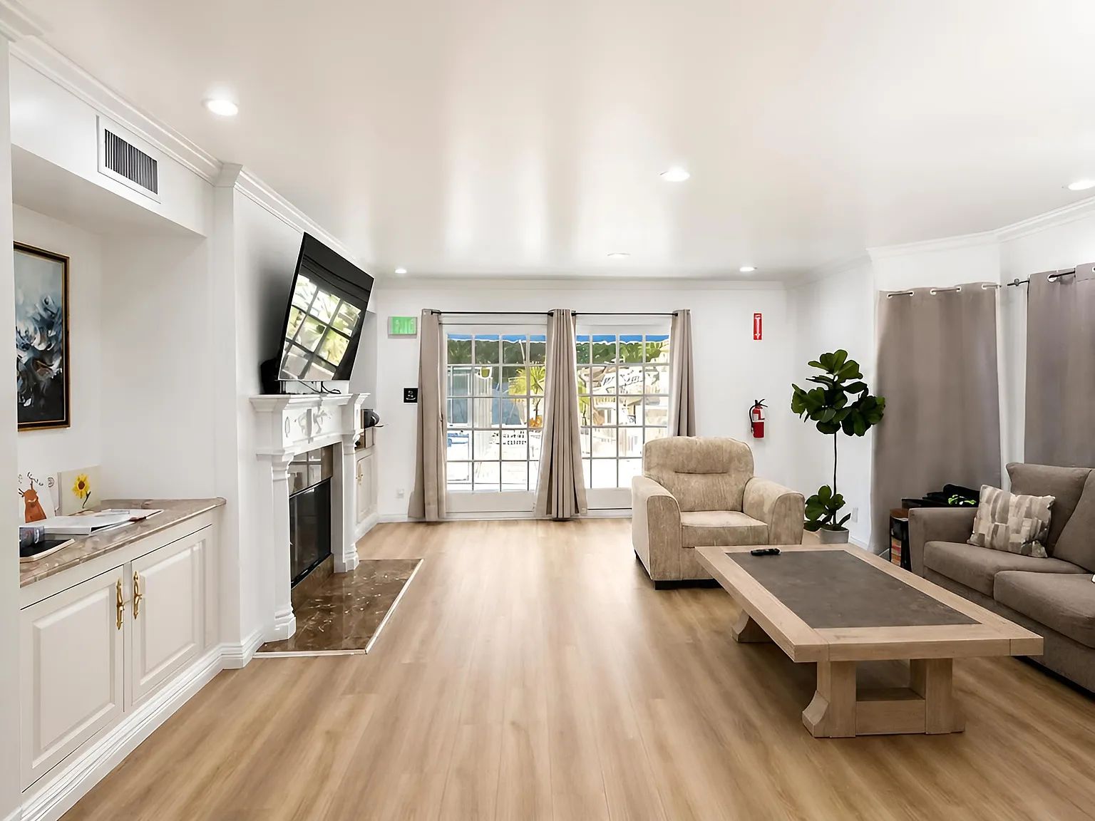A bright common room with a fireplace and sofas